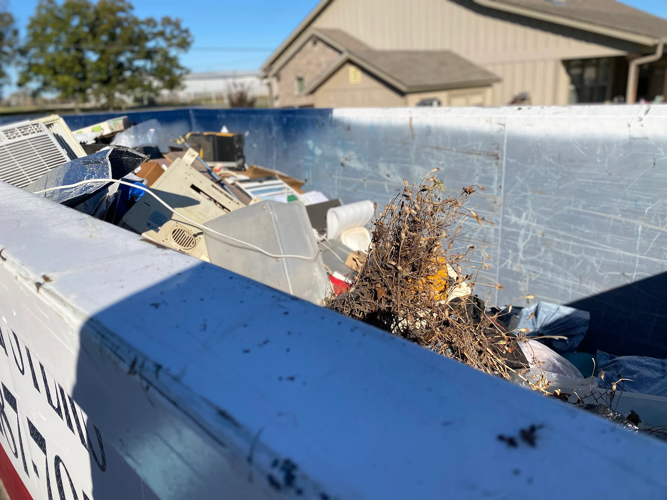 Gentry Dumpster Rentals dumpster on a job in Pottsboro, TX