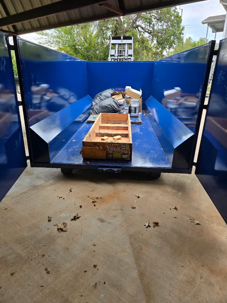 Gentry Dumpster Rentals dumpster being loaded on site in Bryan County, OK